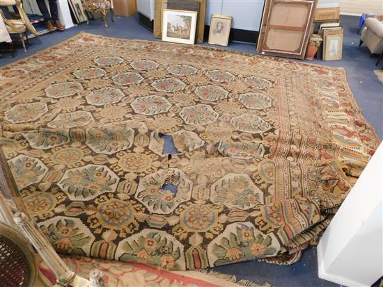 A large Indian carpet, circa 1910, 16ft 1in x 21ft 4in. (652cm x 491cm), fragment 5ft 11in. x 3ft 6in.
